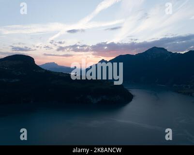 Vierwaldstattersee, Schwyz, located in Inner Switzerland, Aerial drone view of alpine lake road forrest and mountains. Turqoise water and environment Stock Photo