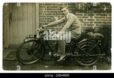 Original 1920's era postcard of happy proud young man or late teen, sitting astride what looks like a brand new Triumph motorcycle, Guildford registration, Surrey, England, U.K. Stock Photo
