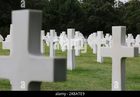 Colleville-sur-Mer, FRA, France - August 21, 2022: American Military Cemetery and many white crosses on the graves of the soldiers Stock Photo