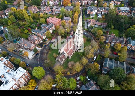 Edgbaston, Birmingham - October 22nd 2022 - The beautiful church of St Augustine of Hippo on Lyttelton Road in the Edgbaston area of Birmingham surrounded by the colours of Autumn. The church is set on a roundabout, surrounded by flats and Victorian properties. The Anglican church spire and tower measures 185 feet tall and is the highest in Birmingham, England. The church was designed by Julius Alfred Chatwin and completed in 1876. Pic Credit: Scott CM/Alamy Live News Stock Photo