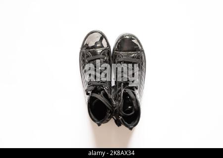 black patent women's shoes torn lies on a white isolated background, women's shoes Stock Photo