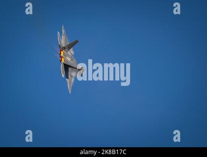 An F-22 Raptor, with after burners on, performs at the 2022 Miramar Airshow at San Diego, California. Stock Photo