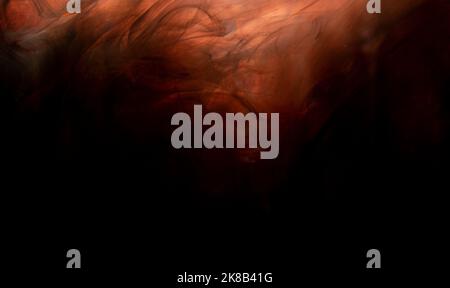 Abstract orange paint making a background wallpaper on black. Stock Photo