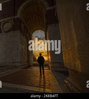 A young man looks towards the sunrise on a new day at Thiepval Memorial to the dead and missing of world war one, Authuille, France Stock Photo