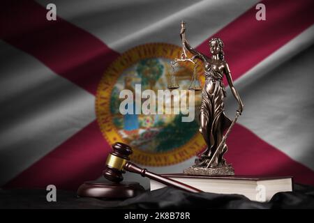 Florida US state flag with statue of lady justice, constitution and judge hammer on black drapery. Concept of judgement and punishment Stock Photo