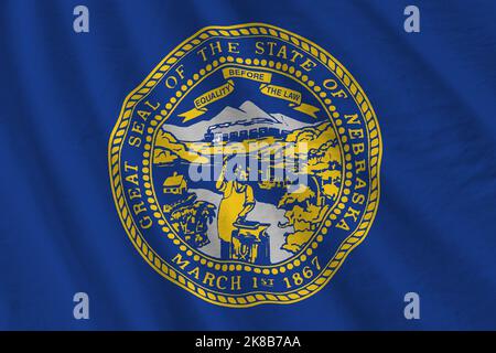 Nebraska US state flag with big folds waving close up under the studio light indoors. The official symbols and colors in fabric banner Stock Photo