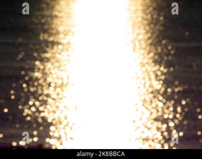 Blurred background. Yellow solar path on the surface of sea waves. Sunset dawn sunrise sundown over the sea. Sea landscape. Natural blurry bokeh texture. Abstract natural background. Seamless looping Stock Photo