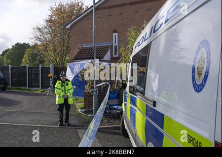 Washington Drive, Birmingham - October 22nd 2022 - A woman collapsed onto the ground with grief crying out for her "brother" who was stabbed and killed on Washington Drive in Handsworth Wood just after 11pm last night (21 Oct). The 29-year-old victim, named locally as "Jamie" was stabbed to death. The woman was consoled by a family friend as she screamed out in agony. Floral tributes and bottles of beer were left at the scene along with heartfelt messages from friends and family. Credit: Scott CM/Alamy Live News Stock Photo