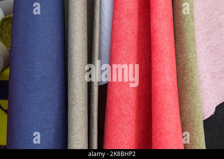 Samples of cloth and fabrics in different colors found at a fabrics market. Stock Photo
