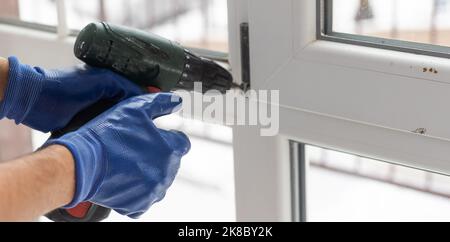 Close up of a mans hand holding screwdriver machine Stock Photo