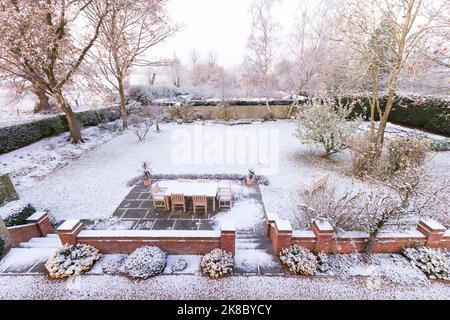 Snow covered garden in winter, UK. Large country backyard or garden in wintry scene Stock Photo
