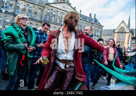 A man wearing strange clothes is seen dancing behind one of the trucks during the demonstration. ADEV (Amsterdam Danst Ergens Voor) which means something like 'Amsterdam Dances For Something' organized for the tenth time its annual demonstration for squatting, free spaces, and affordable housing in the city. Thousands of people danced accompanied by large trucks with loud music systems through the center of Amsterdam. Protesters danced to express their dissatisfaction with what they see as unaffordable housing and argue for more free spaces in the city, and also to be able to squat. Stock Photo