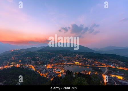 Beautiful landscape view from the top of Mount Hamrong in Sapa city at sunset. Sapa is a famous scenery city in Lao Cai Province in northwest Vietnam, Stock Photo