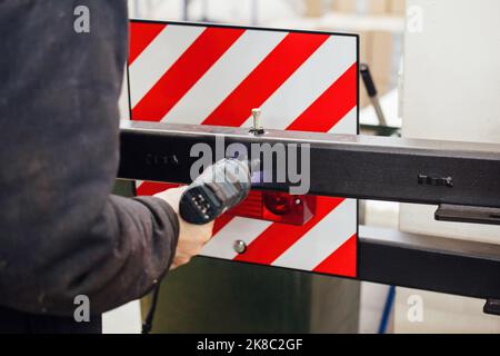 Industrial worker assembles machine, close up. Stock Photo