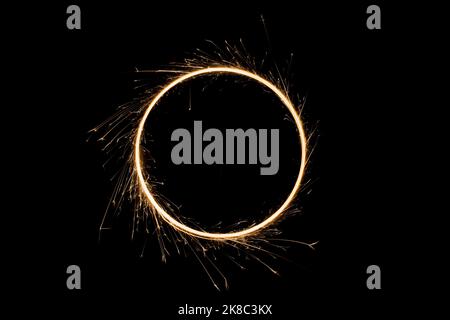 Sparks from the circular rotation of lights on a black background Stock Photo