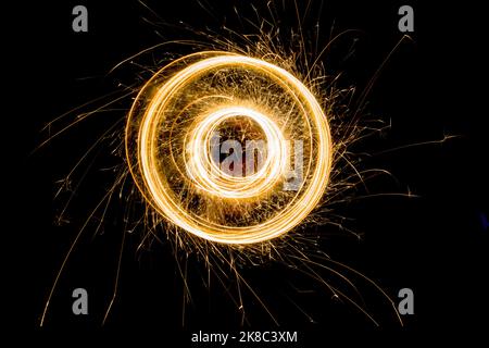 Sparks from the circular rotation of lights on a black background Stock Photo