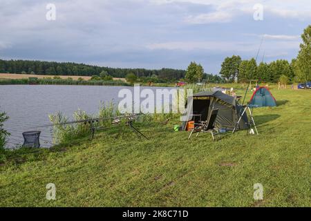 fisherman's tent is set on the shore of the lake Stock Photo