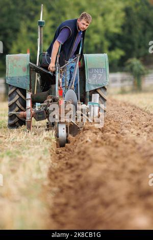 The Sheepy and District 106th Annual ploughing, hedecutting and ditching competition held in North Warwickshire, England. The event showcases the ability to plough using either modern, vintage tractors or horses. Pictured, 16 year old Jack Gilbert from Derby taking part in the competition Stock Photo