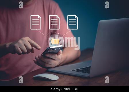 Man using mobile smartphone. Document management system (DMS), online documentation database and process automation to efficiently manage files. Stock Photo