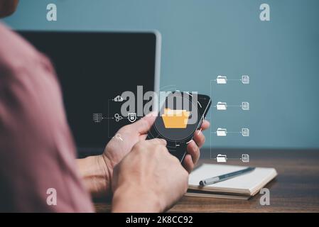 Hand touching on Mobile phone screen with cyber network, Folder, Document,Storage, Server and Cloud computing management concept. Stock Photo