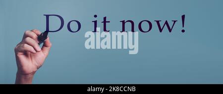 Do it now, Hand writing word for Inspirational phrase, a quote for working mood. Stock Photo