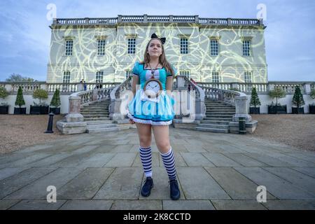 London, UK. 22nd October, 2022. Alice in Wonderland Experience in Greenwich. A young Alice cosplayer prepares to solve clues, complete challenges whilst racing against other teams during an immersive one day event special by Clued Upp Games inspired by the popular Lewis Carol fantasy novel. Credit: Guy Corbishley/Alamy Live News Stock Photo