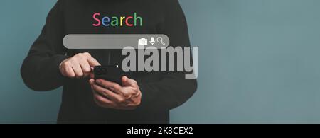 Man hands searching word by written in search bar or search box on virtual screen, browsing Internet global data Information. Stock Photo