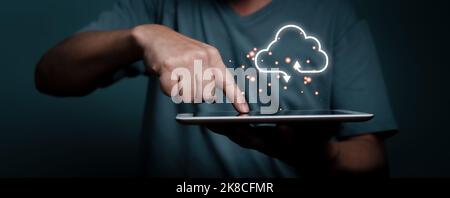 Hand touching tablet with white cloud computing network technology concept. Stock Photo