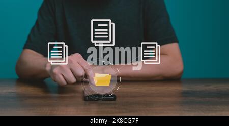 Man using mobile smartphone. Document management system (DMS), online documentation database and process automation to efficiently manage files. Stock Photo