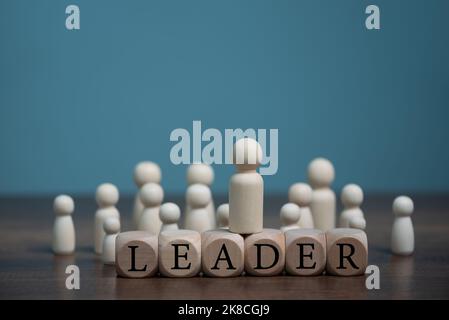 Leader of the business team concept, indicates the direction of the movement towards the goal. Crowd of people goes for the leader, isolated on light Stock Photo