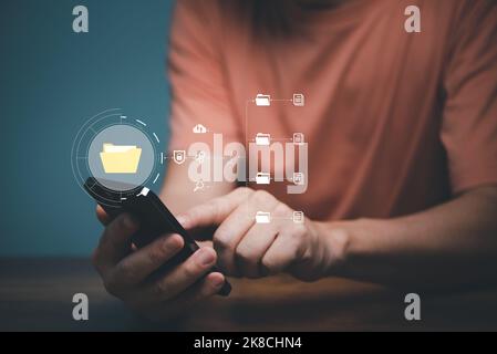 Man using mobile smartphone. Document management system (DMS), online documentation database and process automation to efficiently manage files. Stock Photo