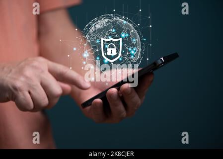 Cyber security connection shield technologies background, Human finger touching on mobile phone with global network linking technology. Stock Photo