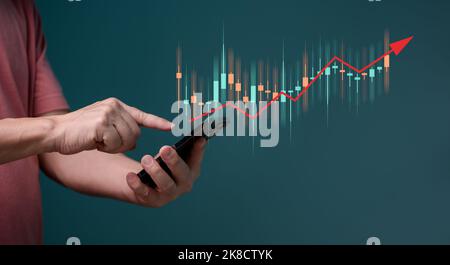 Hand of Businessman people or trader is showing a growing virtual hologram stock on smartphone, planning and strategy, Stock market, Business growth, Stock Photo