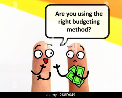 Two fingers are decorated as two person. They are discussing about finances. One of them is asking another person if he is using the right budgeting m Stock Photo