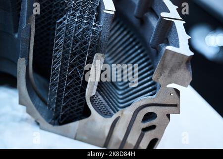 Complicated detail made by powder 3d printer in workshop Stock Photo