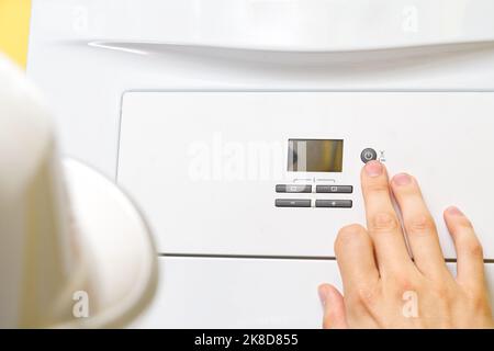 Setting up and servicing by a service department. Adjustment of gas boiler at domestic home. Stock Photo
