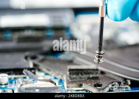 Hands of a technician repairing a broken laptop computer Stock Photo
