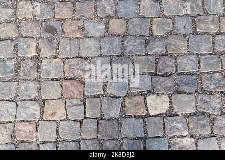 Old pavement of granite background. Top view on stone road close up. Stock Photo