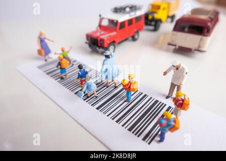 Miniature toys school kids walk on cross road bar code - school children road safety concept. Stock Photo