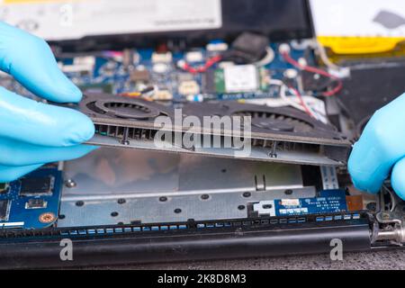 Hands of a technician repairing a broken laptop computer Stock Photo