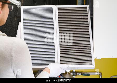 Replacing filter in the central ventilation system. hvac filter replacing home central air system Stock Photo