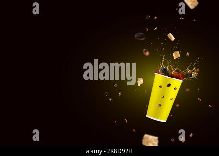 takeaway paper cup with splashing coffee. falling disposable paper cup with coffee splash Stock Photo