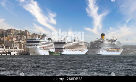 Three huge cruise ships docked at terminal of Galataport, located along shore of Bosphorus strait, in Karakoy neighbourhood, with Galata tower in the background, Istanbul, Turkey  Stock Photo