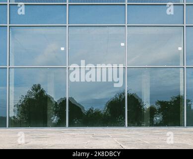 scenery reflection on brand new commercial office building glassy facade Stock Photo