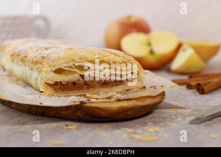 apple pastry strudel roll with cinnamon on grey marble table Stock Photo