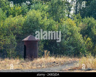 Steel cover for a marksman in a basalt quarry. Safety shelter for explosive work on mine Stock Photo