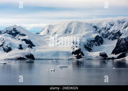 looking to the far end of paradise harbour (bay) with glacier and snow covered peaks of antarctic peninsula. antarctica Stock Photo