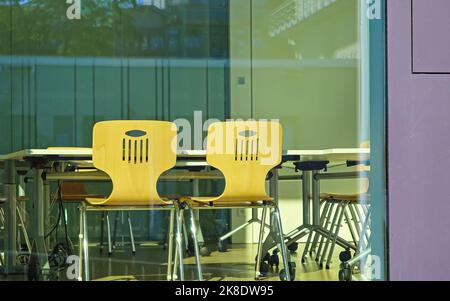 Empty modern office room, two chairs and table - skilled stuff shortage and business abandonment concept Stock Photo