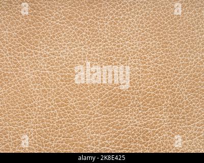 Beige leather texture. Background with copy space, top view. Genuine leather sample closeup in light beige tone. Backdrop textured effect for design Stock Photo
