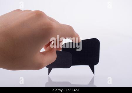 Hand holding dialogue boxes on a white background Stock Photo